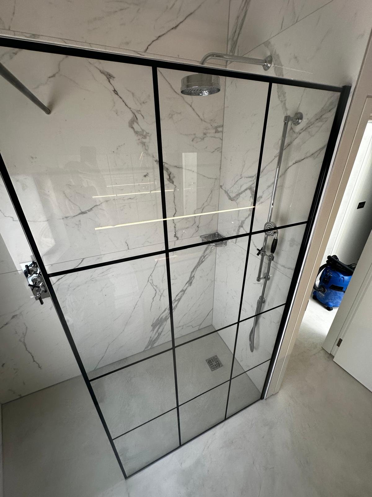 Luxury bathroom with marble tiles and walk-in shower